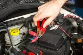 Jumper cables attached to a car battery for jumpstart service in Ontario, CA
